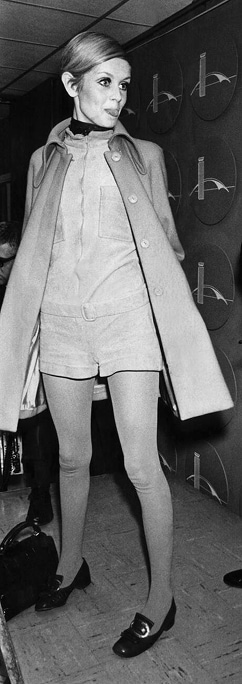 Twiggy, vêtue d’une combinaison et d’un caban, tire la langue aux photographes.